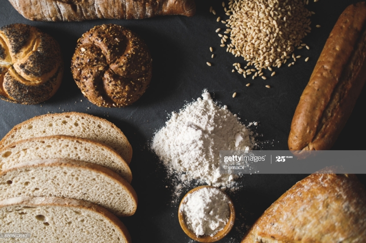 Many mixed breads and rolls shot from above.